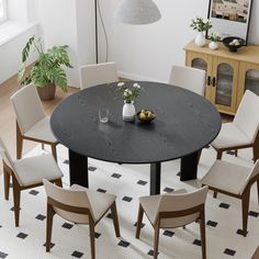 a dining room table with white chairs around it