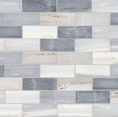 a white and grey tile wall with different colors