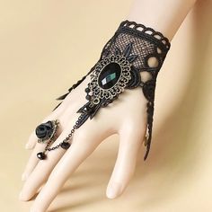 Enhance your style with the exquisite Gothic Lace Ring Bracelet. This one-of-a-kind accessory showcases intricate lace embroidery, a dainty rose ring connected by a chain, and captivating gemstones. The elegant black tone effortlessly adds a touch of sophistication to any ensemble. Discover the ultimate fusion of edgy and chic with this essential fashion piece that elevates your look. Intricate lace embroidery Dainty rose ring connected by a chain Captivating gemstones Elegant black tone Choker Designs, Lace Necklace, Hand Chain, Hand Jewelry, Crystal Charm