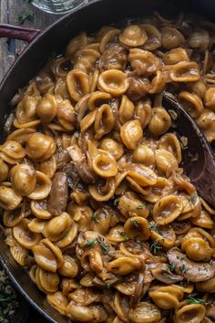 a skillet filled with pasta and mushrooms