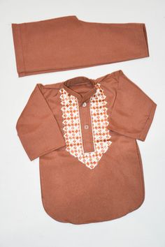 Description Colour: Dark Brown Fabric: 100% Cotton Dress Front: Embroidery  This is a handmade outfit for infant, toddler and kid boys. It includes a top and bottom with machine embroidery front. It would be an ideal outfit for occasions such as birthdays, Eid and Weddings or a perfect gift. Available in sizes:  *3-6 months *6-9 months *12-18 months (1-1.5 years old) *18-24 months (1.5-2 years old) Top / Kurta  *Breathable and easy-to-wash cotton fabric *Easy open and close clasp-buttons *No-itc Fitted Brown Cotton Sets, Brown Sets With Resham Embroidery For Diwali, Brown Resham Embroidered Sets For Diwali, Brown Resham Embroidery Sets For Diwali, Brown Long Sleeve Sets With Resham Embroidery, Brown Sets With Resham Embroidery And Long Sleeves, Cotton Sets For Traditional Ceremonies, Long Sleeve Cotton Sets With Multicolor Embroidery, Semi-stitched Sets With Multicolor Dabka Embroidery