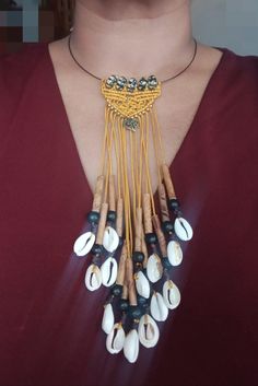 Ethnic necklace inspired by Creole culture, black steel choker, macramé pattern falling like openwork braids of bamboo tubes, Acai beads and cowrie shells, made by me. Black steel choker on which I placed 5 glass beads and made a small macramé pattern. I left a length of thread so as to give the impression of movements like the braids beautifully adorned with bamboo tubes, black Acai seeds and cowrie shells. - Steel necklace: approximately 45 cm in length and screw clasp - 5 glass beads 1.5 cm i Creole Culture, Round Pouch, Small Macrame, Cowrie Shells, Ethnic Necklaces, Long Braids, Cowrie Shell, Macrame Patterns, Steel Necklace