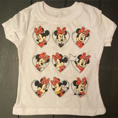 a white shirt with mickey and minnie mouse patches on it