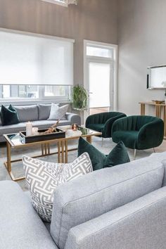 a living room with couches, chairs and coffee table in it's center