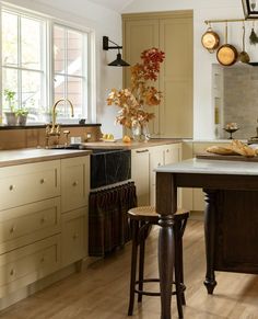 a kitchen filled with lots of counter top space and wooden flooring next to a window