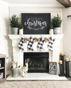 a fireplace with stockings hanging from it's mantle and christmas decorations on the mantel