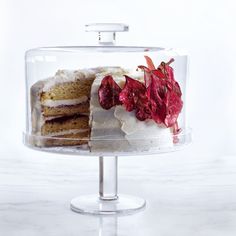 a cake in a glass dish with flowers on top