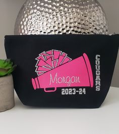 "Custom Black Canvas Cheerleader or Dance Team name makeup/cosmetic bag.  Treat yourself or show your appreciation to your team with this stylish, personalized and practical makeup bag.  Many colors available, trendy and fashionable.  Lightweight, durable, easily fits into your suitcase, handbag or backpack. Other Information:   *This bag is customizable- just put your special request on the \"Notes\" area on the order page. * This design is also available in a white makeup bag. *This design is also available on a tote bag (perfect to carry large items) or t-shirt (perfect to show off the group team spirit!)  Send us a message for details. *Bag size: 9.5\" x 6.75\" x with a 3\" bottom *If you have any questions, please contact us before placing your order *We offer discounts on bulk orders Cheer Makeup Bag, Cheerleader Christmas Gifts, Cheerleading Bags, Cheer Makeup, Cheer Team Gifts, Personalized Makeup Bag, Pom Pom Girl, Personalized Makeup Bags, White Makeup