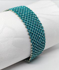 Teal- silver beacelet  Sometimes a simple but quite recorativevbracelet is required. This is such a beacelet!  The smoothness of the flat chenille stitch gives this bracelet an extra chick. I created this 18 cms long, IT closee with a slide ín magnetic clasp. The jewellery will be posted from Hungary via postal services. If you have any further questions, do not hesitate to contact me. Silver Beaded Bracelets With Strap For Party, Silver Tiny Beads Bracelet For Party, Silver Bracelets With Tiny Beads For Party, Silver Bracelet With Tiny Beads For Party, Silver Beaded Bracelets With Round Beads, Elegant Silver Braided Bracelets With Round Beads, Elegant Beaded Braided Bracelets, Elegant Beaded Braided Bangle Bracelet, Elegant Handmade Friendship Bracelets For Party