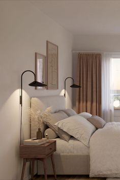 a white bed sitting next to a window with two lamps on each side of it