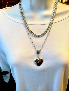 "Bold, statement heart locket pendant and  your choice of a  heavy silver chain or a long smaller link chain. Heavy silver Chain - Photo #2 - is 1/4 inch wide and measures 17\" long with a 3 inch extender. Cable link silver chain is 28\" long.  Large puffed locket heart pendant measures 1.25\" long and 1 inch wide. This beautiful locket has the word love itched on the front and it holds two photos. It slides  on either chain which makes this set very versatile." Valentine's Day Silver Chain Necklace With Adjustable Chain, Valentine's Day Silver Charm Necklace With Chain, Valentine's Day Silver Heart Necklace With Chain, Valentine's Day Silver Charm Necklace, Silver Double Heart Necklace With Chain, Silver Heart Charm Necklace For Valentine's Day, Silver Chain Necklace With Heart Charm For Valentine's Day, Silver Heart Necklace With Chunky Chain, Silver Heart Necklace With Chunky Chain For Gifts