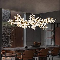 a dining room with a large chandelier hanging from the ceiling