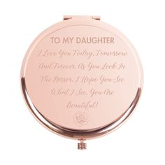 a pink compact mirror with the words to my daughter on it