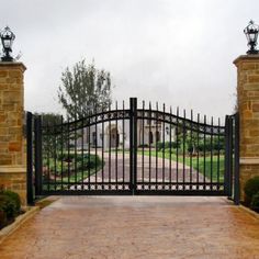 an iron gate is open to the driveway