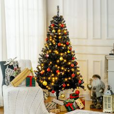 a decorated christmas tree in a living room with presents on the floor next to it