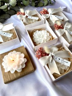 several small boxes with flowers in them on a table