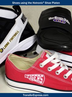 three pairs of shoes sitting on top of each other with the word tigers painted on them