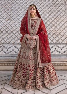 a woman in a red and gold bridal gown