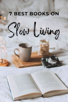 an open book on top of a bed next to a camera and coffee cup with the words 7 best books on slow living