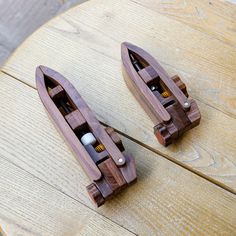 two small wooden boats sitting on top of a table