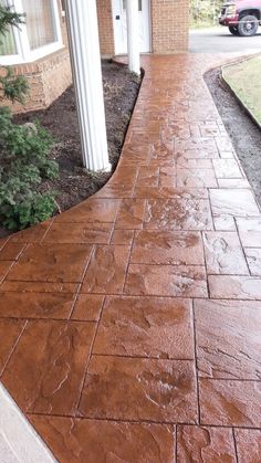 a brick walkway in front of a house