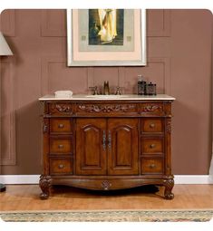 a bathroom vanity with a painting on the wall