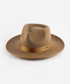 Our Monroe Rancher felt fedora hat is a bestseller for good reason, this quintessential wool fedora hat stands the test of time making it the perfect staple in any wardrobe. The Monroe Rancher is a hat with a teardrop shaped crown, stiff upturned brim, and is paired with a tonal grosgrain band. These beautiful combinations make this felt fedora hat a classic. Wool Fedora Hat, Wool Fedora, Felt Fedora, Hat Stands, Halo Style, Wearing A Hat, Find Color, Felt Hat, Fedora Hat