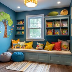 a child's room with blue walls and colorful pillows on the window seat, bookshelves