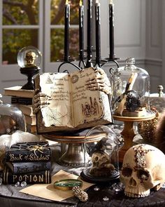 a table topped with lots of books and skulls