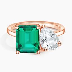 an emerald and diamond ring with rose gold accents