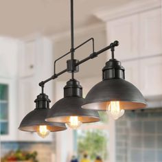 three lights hanging from the ceiling in a kitchen