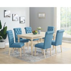 a dining room table with blue chairs around it