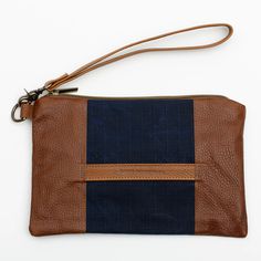 Stylish and durable, this Eastport Clutch is made to accompany you on all of your travels. Perfect for those on the go! Attach the Eastport Clutch to the inside of the Saco River tote Bag or the Fore Street Tote Bag (sold separately) to make a stylish set. Due to the nature of the leather, variations in color may occur. Made in a solar-powered workshop in Maine. Includes detachable leather wrist strap with a bronze lobster clasp built-in leather hand clutch strap zip-top closure Materials waxed Rockport Maine, Hand Clutch, Navy And Brown, Waxed Canvas, Solar Powered, Leather Purse, Zip Top, Wrist Strap, Full Grain Leather