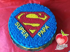 a blue cake with a superman logo on it