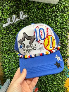 We can make you the perfect custom Sports Mom hat. You can choose your sport, colors, child's name, jersey number or initials. We add in some cute accent patches and you'll be the coolest mom at the game!  Each hat comes with a beaded brim bracelet for that extra team spirit :) Message us BEFORE ordering to be sure we have the patches you want. We offer lots of other styles. Feel free to browse our HAT SECTION and see what we have. You may just find your favorite hat. NO refunds or exchanges on custom orders. Fan Gear Baseball Cap In Team Colors, Sporty Snapback Hat For Game Day, Game Day Snapback Hat With Team Spirit, Team Spirit Hats For Sports Season, Game Day Sports Fan Hats With Letter Print, Sports Fan Hat With Letter Print For Game Day, Sports Fan Fitted Hat For Baseball Season, Team-colored Hats With Letter Print For Game Day, Team-colored Fitted Hat For Sports Fans