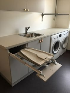 a kitchen with a washer and dryer in it