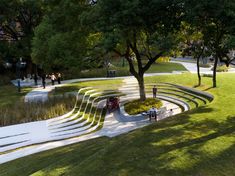 an aerial view of a park with benches and trees