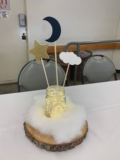 there is a mason jar with stars and moon sticks in it on top of a table