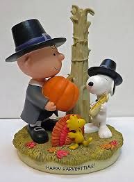 a figurine of a boy with a dog and pumpkin next to a tree