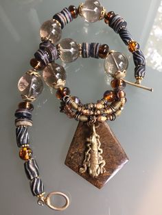 Sybilla - Rutilated quartz, African beads, Czech hand-made and more by RedShoesDancing on Etsy https://www.etsy.com/listing/253244913/sybilla-rutilated-quartz-african-beads Artisan Brown Jewelry With Natural Inclusions, Bohemian Brown Czech Glass Jewelry, Brown Smoky Quartz Jewelry With Natural Stones, Handmade Brown Smoky Quartz Jewelry, Earthy Brown Czech Glass Jewelry, Bohemian Adjustable Necklace With Natural Inclusions, Bohemian Smoky Quartz Jewelry Gift, Handmade Spiritual Smoky Quartz Jewelry, Nature-inspired Brown Jewelry With Gemstone Beads