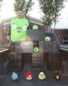 a man is standing in the back of a pick up truck with angry birds on it