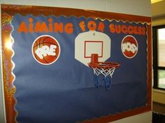 a bulletin board with basketballs and hoop in the middle of a gym room wall