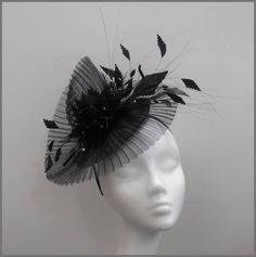 An elegant and sophisticated pleated black crinoline fascinator. Trimmed with gorgeous feathers and subtle black diamantés. A great addition to any special occasion outfit. Made on a headband. Perfect headpiece for ladies day, special occasion or formal event. Please note this fascinator is made to order, orders take approximately 2-3 weeks to be made.  Designs can be made to order in a range of different colours or styles, see our colour chart: www.jacquivaledesigns.com/colour_chart.html Please Pleated Crinoline Fascinator, Black Costume Hats For Royal Ascot Party, Evening Fascinator With Feather Trim, Elegant Black Feather Trim Costume Hat, Elegant Black Fascinator With Feather Trim, Elegant Party Fascinator With Feather Trim, Elegant Black Costume Hat With Feather Trim, Elegant Black Party Costume Hats And Headpieces, Black Mini Hat For Wedding At Royal Ascot