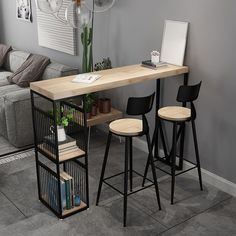 a table with three stools in front of it and a couch behind the table