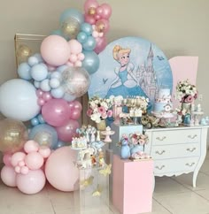 a table topped with balloons and cake next to a princess themed party set up on top of a tile floor