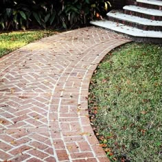 a brick walkway with steps leading up to it