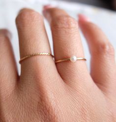 Simple and dainty tiny crystal pearl ring that's perfect for layering. The pearl is a round freshwater approximately 3mm. Pearls are always a classic and will never go out of style. The band is a gold-filled material and is non-tarnish. Wear it to sea, pool, spa, or just anywhere! Made in California Everyday Adjustable 14k Gold Pearl Ring, Delicate Everyday Stackable Rings, Everyday Stackable Pearl Ring, Adjustable Everyday Pearl Drop Rings, Adjustable Stackable Pearl Ring For Everyday, Everyday Adjustable Stackable Pearl Ring, Classic Adjustable Pearl Ring, Minimalist Pearl Stackable Jewelry, Delicate Tiny Midi Rings For Everyday