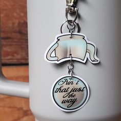 a mug with a keychain that says, don't trust the dog