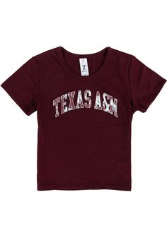 Kids, show your support for your favorite team in this Texas A&M Aggies Girls Maroon Short Sleeve Tee! This T-Shirt features a screenprint team graphic, so everyone will know you cheer for the Texas A&M! This is the perfect Texas A&M Aggies Girls T-Shirt for wearing from every day to game day. Gig 'Em! Screenprint team graphic, 65% POLYESTER / 35% COTTON, Short sleeve, Crew neckline, Perfect for any young sports fan!, 65% POLYESTER / 35% COTTON, 8 Fitted School Spirit T-shirt With Letter Print, Fitted T-shirt With Letter Print For School Spirit, Varsity Cotton Top With Team Logo, Varsity Cotton Tops For School, Cotton Varsity Tops For School, Team-colored Tops With Team Logo For Cheerleading, Team-colored Cheerleading Tops With Team Logo, Cheerleading Team Spirit Tops With Logo, Cheerleading Tops With Team Logo