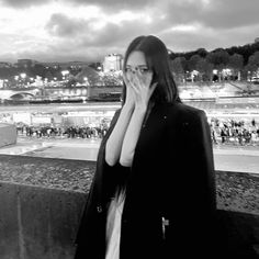 black and white photograph of a woman covering her face